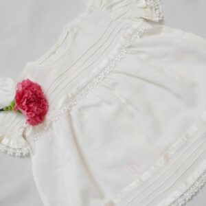 Frocks In White Self Woven fabric With Pintucks,Delicate Laces &ribbons